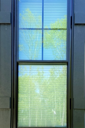 Here is an example of exterior 80% window film showing a slight blueish green hue on the top pane and no film on the bottom pane.